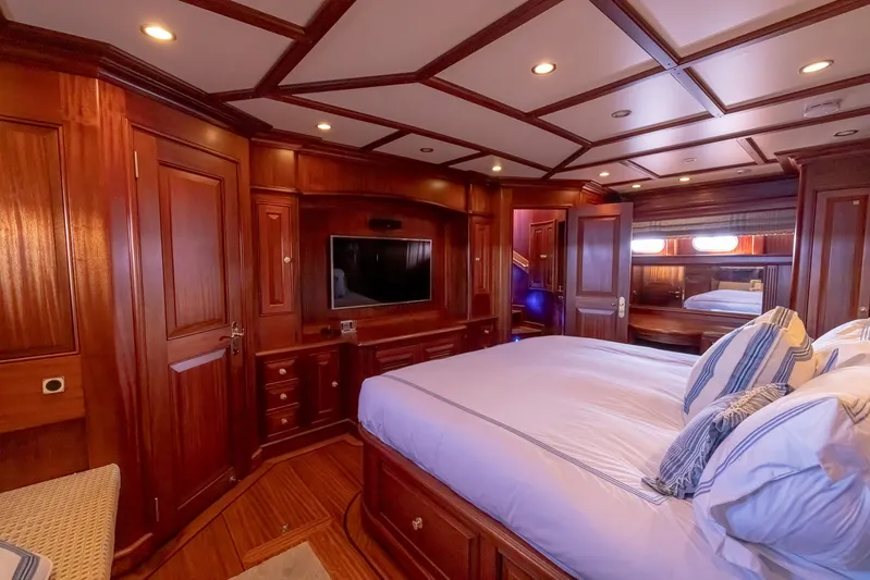Essence Yacht Photos Pics Luxurious wood-paneled bedroom interior of 2006 Vicem 85 Classic yacht with elegant furnishings.