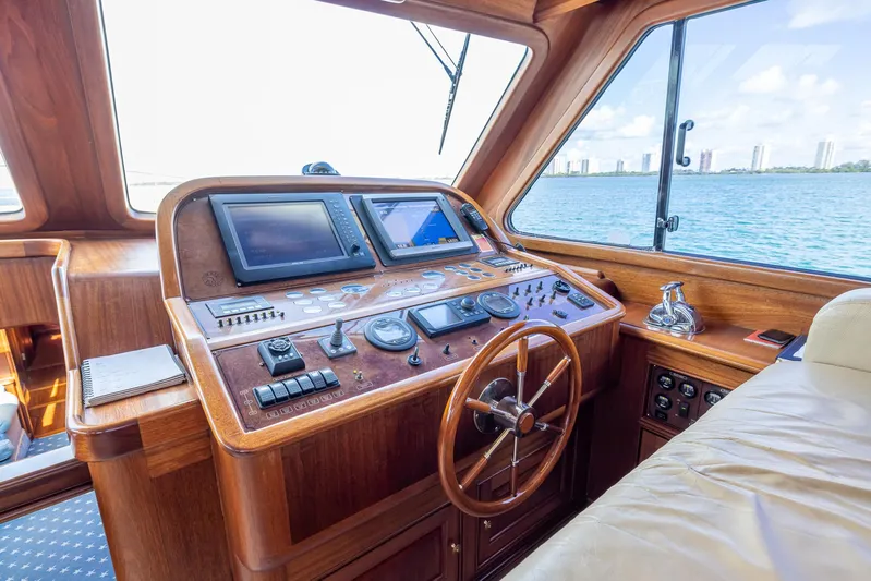 Essence Yacht Photos Pics Helm of 2006 Vicem 85 Classic yacht with wooden dashboard and navigation equipment.