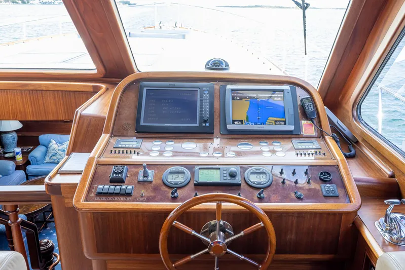 Essence Yacht Photos Pics 2006 Vicem 85 Classic yacht helm with navigation screens and wooden steering wheel.