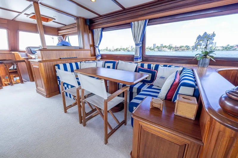 Essence Yacht Photos Pics Interior of 2006 Vicem 85 Classic yacht with striped seating and wooden furnishings.