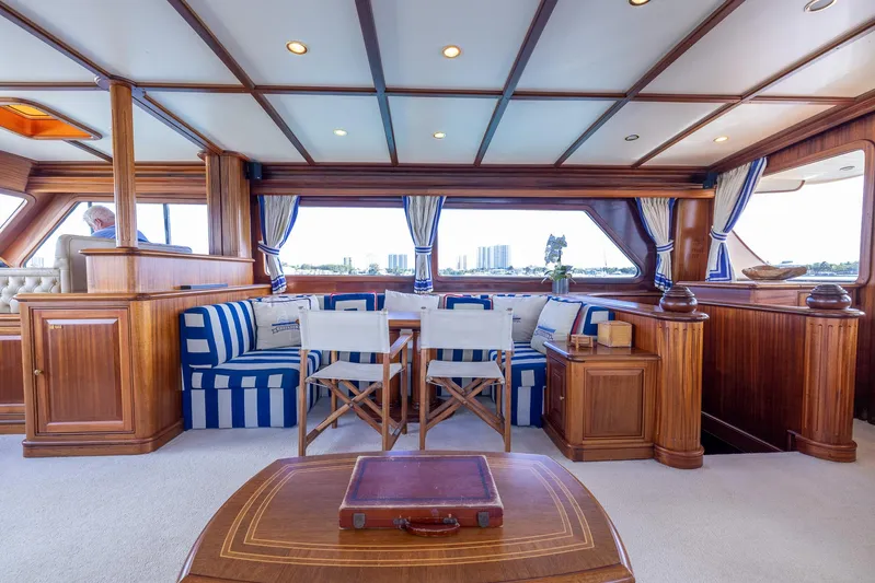 Essence Yacht Photos Pics Luxurious interior of 2006 Vicem 85 Classic yacht with elegant wood and striped seating.