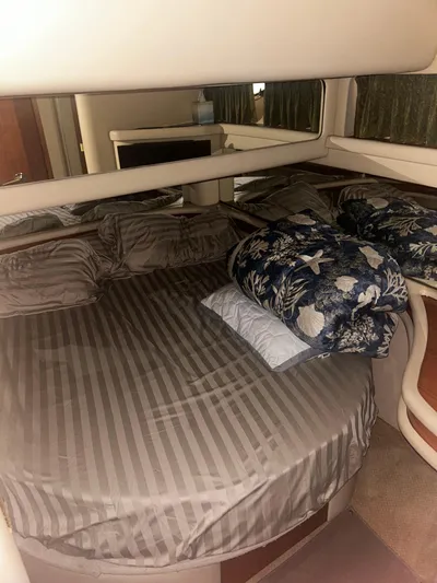 Another Chapter Yacht Photos Pics 1999 Sea Ray 480 Sedan Bridge cabin with striped bedding and floral pillows.