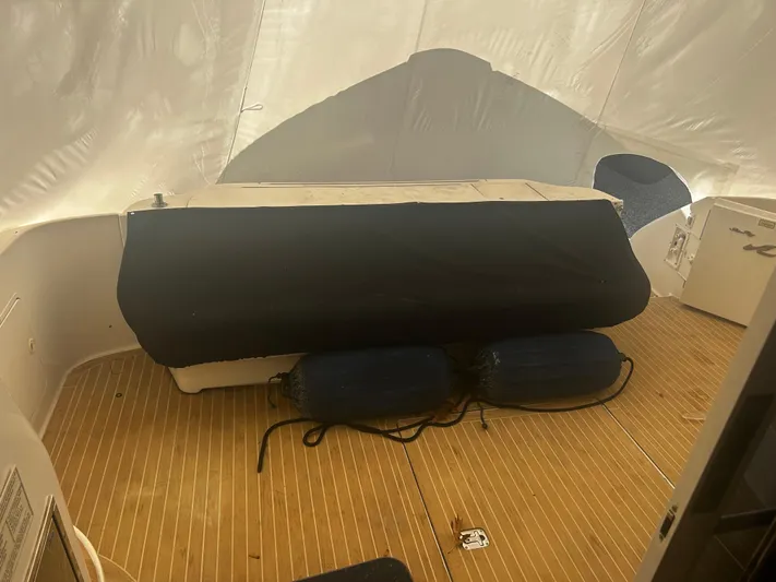 Another Chapter Yacht Photos Pics 1999 Sea Ray 480 Sedan Bridge interior with wooden flooring and covered seating area.