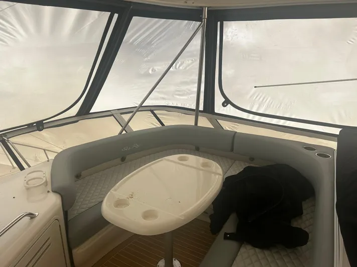 Another Chapter Yacht Photos Pics Interior of a 1999 Sea Ray 480 Sedan Bridge with seating and table.