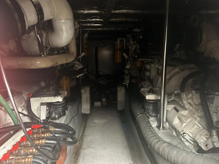 Another Chapter Yacht Photos Pics Engine room of a 1999 Sea Ray 480 Sedan Bridge, showcasing mechanical components and piping.