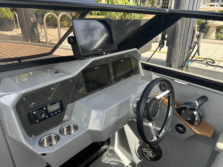 Rand Leisure 28 Yacht Photos Pics 2021 Rand Leisure boat dashboard with steering wheel, navigation screens, and controls.