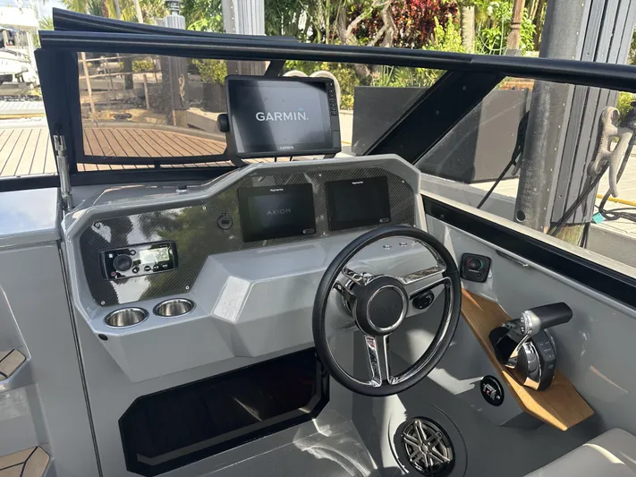 Rand Leisure 28 Yacht Photos Pics Interior of a 2021 Rand Leisure boat with Garmin navigation system and modern steering wheel.