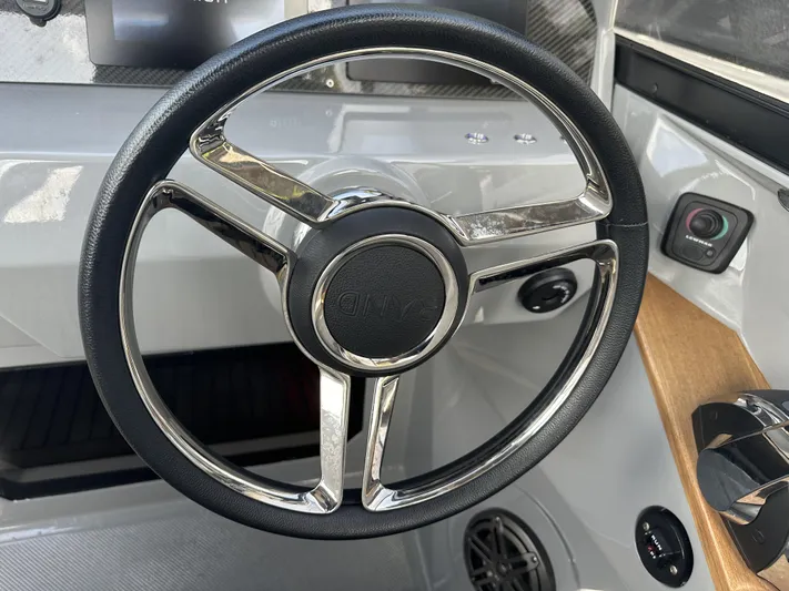 Rand Leisure 28 Yacht Photos Pics Steering wheel of a 2021 Rand Leisure boat, featuring sleek design and modern controls.