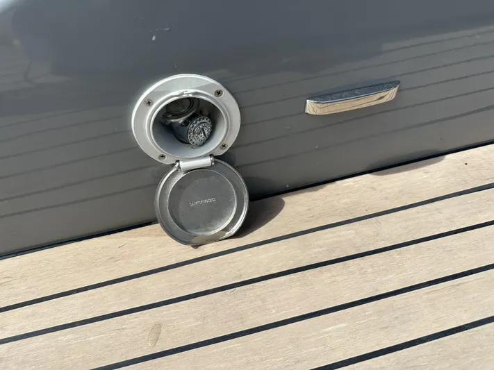 Rand Leisure 28 Yacht Photos Pics Fuel cap on a 2021 Rand Leisure boat, open on a wooden deck.