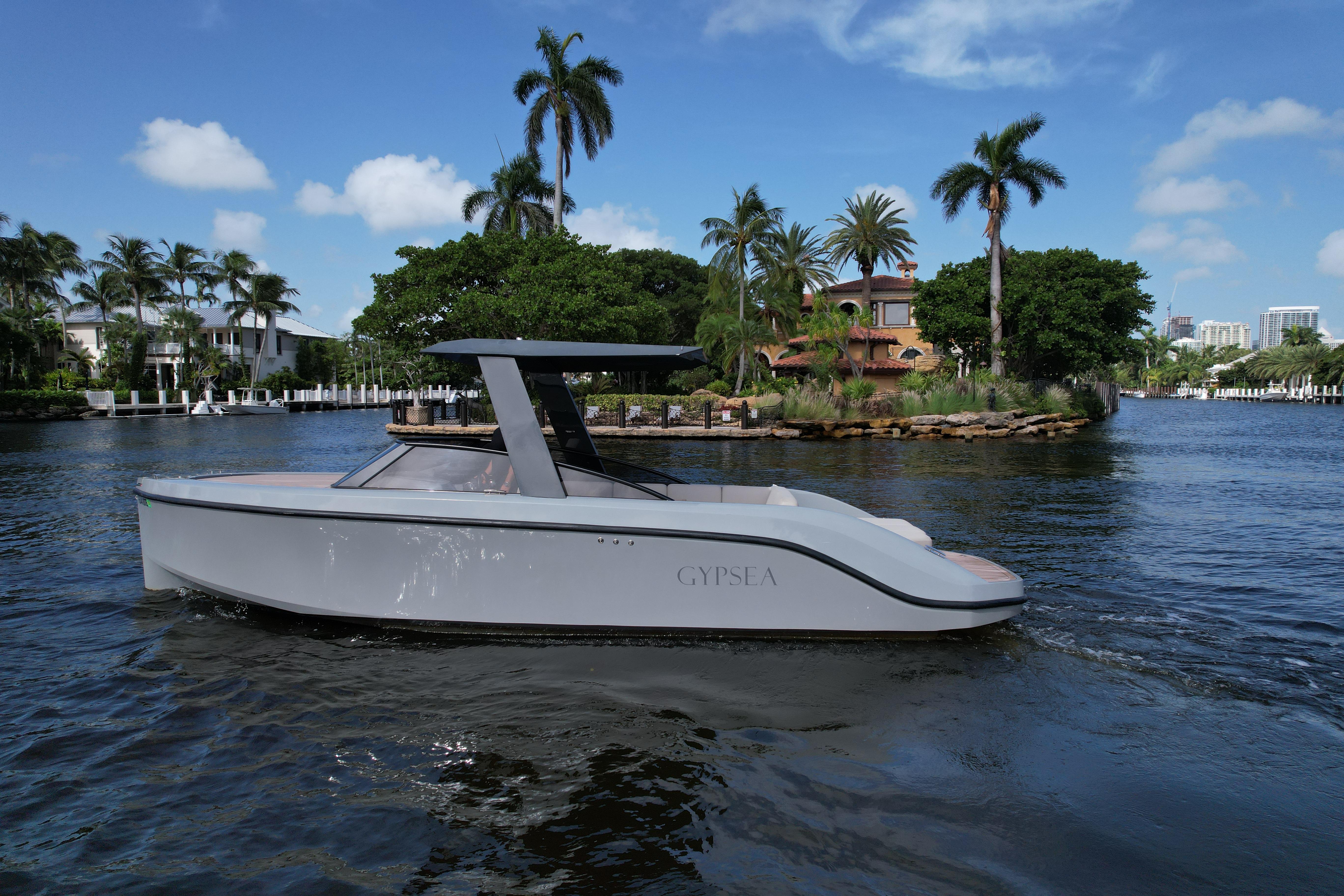 Modern 2021 Rand Leisure boat cruising on a scenic, tropical waterway.