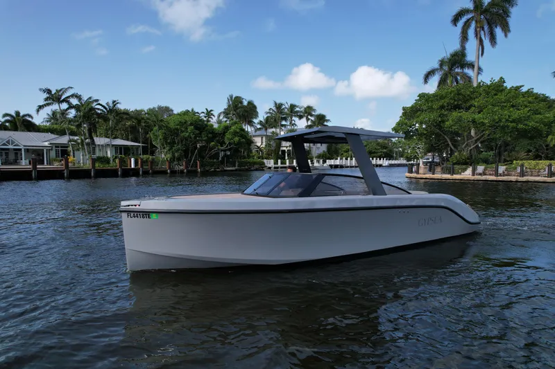 Rand Leisure 28 Yacht Photos Pics Modern 2021 Rand Leisure boat cruising on a scenic waterway with palm trees.