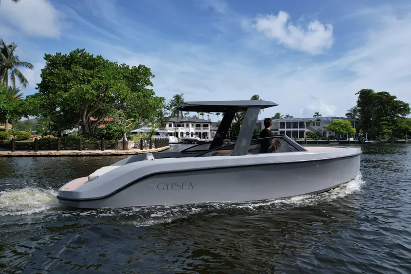 Rand Leisure 28 Yacht Photos Pics Modern Rand Leisure 2021 boat cruising on a scenic waterway with lush greenery.