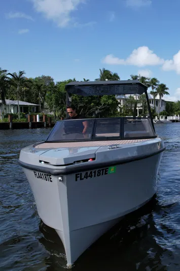 Rand Leisure 28 Yacht Photos Pics 2021 Rand Leisure boat cruising on a sunny day with palm trees in the background.