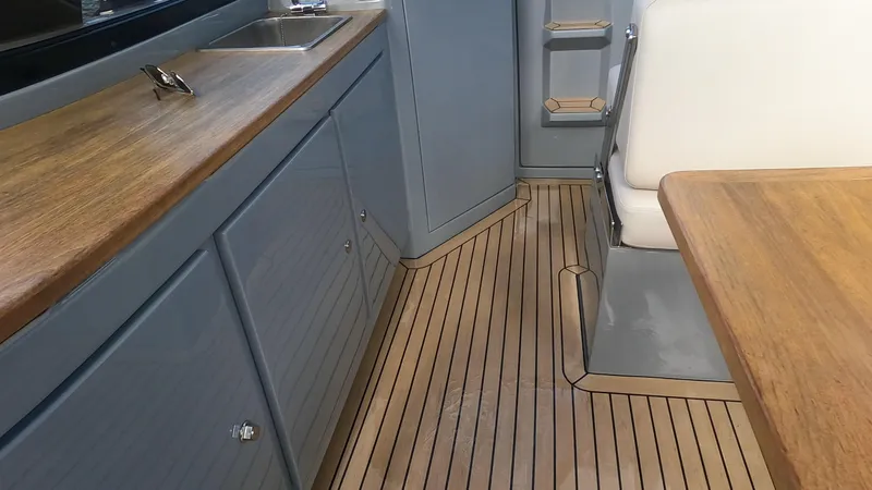 Rand Leisure 28 Yacht Photos Pics Interior of 2021 Rand Leisure boat with wooden flooring and modern cabinetry.