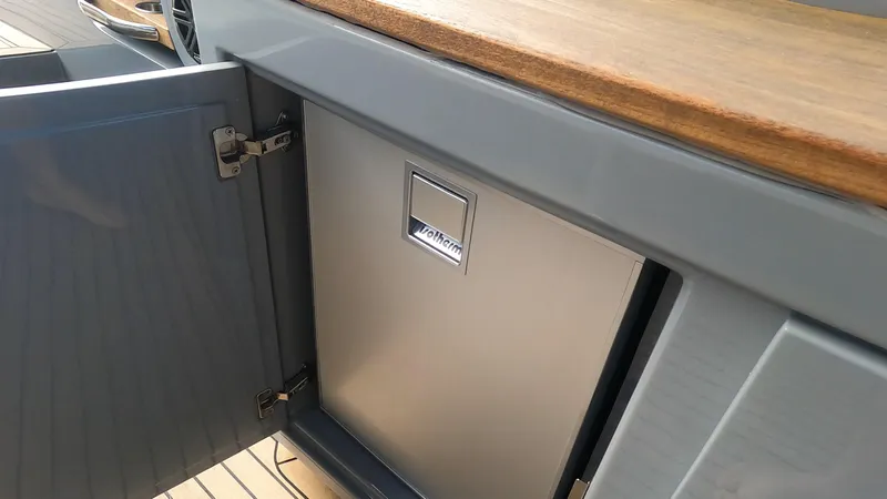 Rand Leisure 28 Yacht Photos Pics Open cabinet on Rand Leisure 2021 boat with built-in refrigerator.