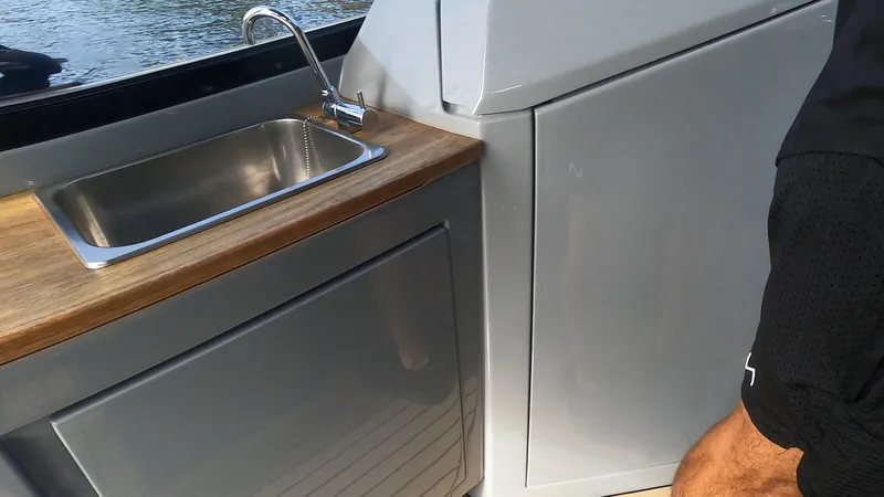 Rand Leisure 28 Yacht Photos Pics Modern boat kitchen with stainless steel sink and wooden countertop, Rand Leisure 2021 model.