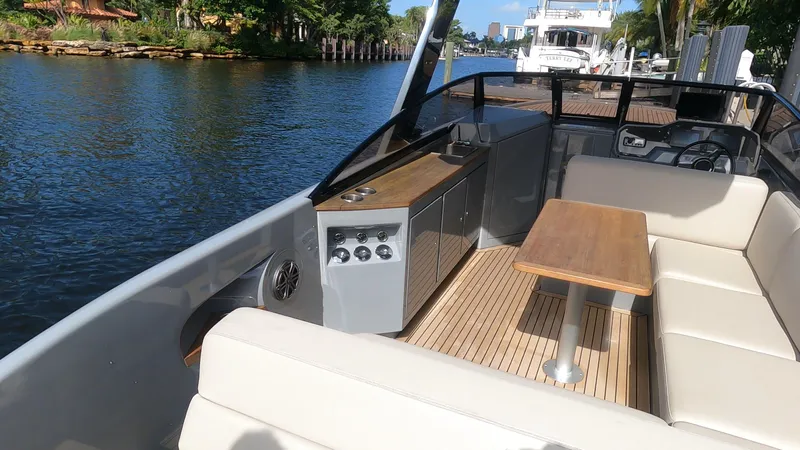 Rand Leisure 28 Yacht Photos Pics 2021 Rand Leisure boat interior with seating and table on a sunny day.