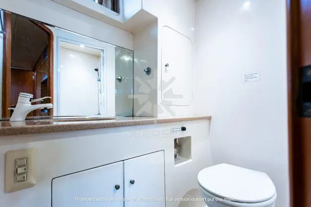 Luxurious bathroom in a 2002 Vitech 58 yacht, featuring modern fixtures and ample storage.