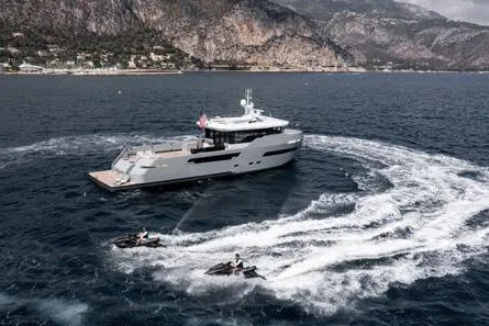 Crossover 27 #1 Yacht Photos Pics 2024 Lynx Crossover 27 yacht with jet skis in scenic coastal waters.