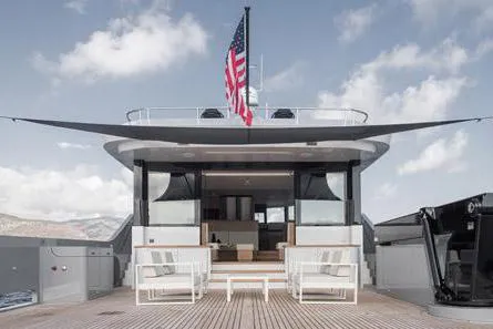 Crossover 27 #1 Yacht Photos Pics 2024 Lynx Crossover 27 yacht deck with seating, American flag, and open sky.