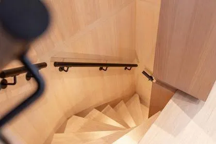 Crossover 27 #1 Yacht Photos Pics Spiral staircase in 2024 Lynx Crossover 27, featuring sleek wooden design and black handrails.