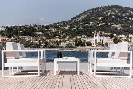 Crossover 27 #1 Yacht Photos Pics Luxury yacht deck with white seating, scenic coastal view; Lynx Crossover 27, 2024 model.