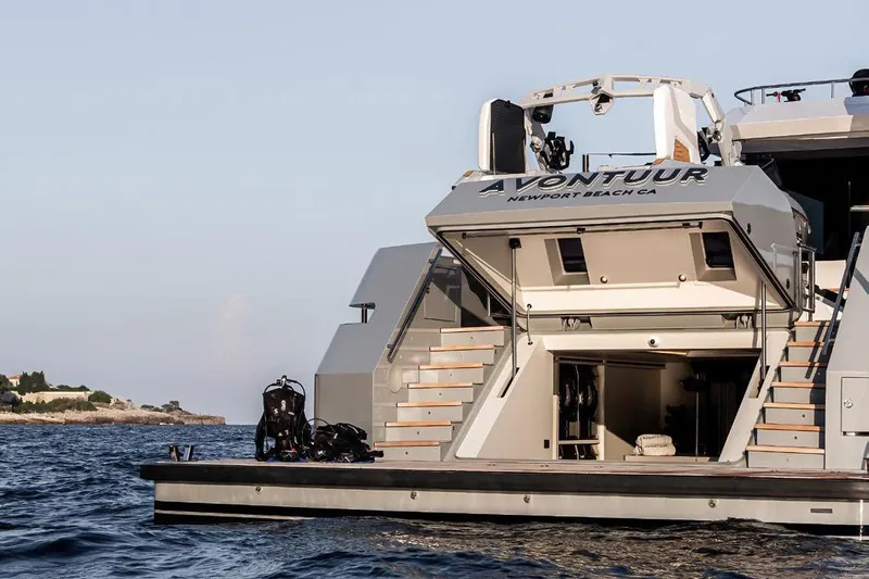 Crossover 27 #1 Yacht Photos Pics 2024 Lynx Crossover 27 yacht with open deck, docked near a scenic coastline.