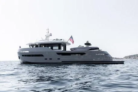 Crossover 27 #1 Yacht Photos Pics 2024 Lynx Crossover 27 yacht on open water, sleek design, American flag displayed.