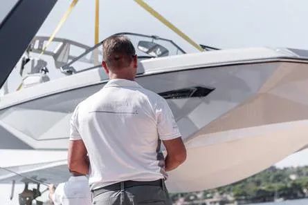 Crossover 27 #1 Yacht Photos Pics Man observing 2024 Lynx Crossover 27 boat being lifted by crane.