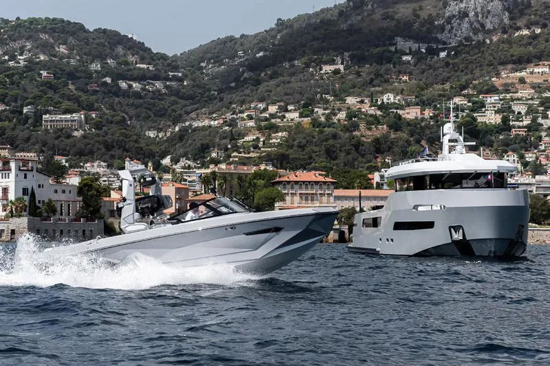 Crossover 27 #1 Yacht Photos Pics 2024 Lynx Crossover 27 yacht cruising near a coastal town with scenic hills.
