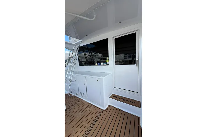  Yacht Photos Pics 1999 Viking 50 Convertible yacht with teak deck and white exterior.