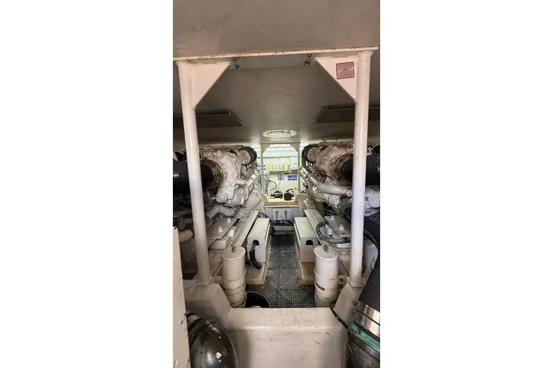  Yacht Photos Pics Engine room of 1999 Viking 50 Convertible yacht, showcasing dual engines and mechanical components.