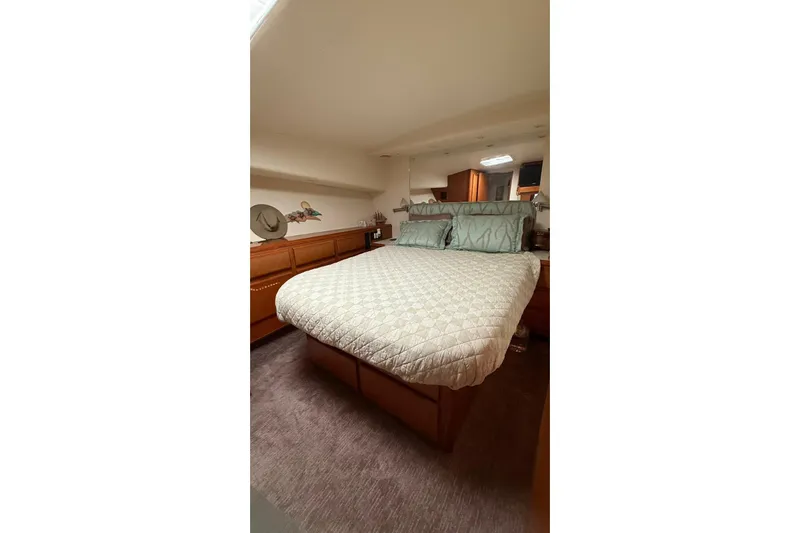  Yacht Photos Pics Luxurious bedroom interior of 1999 Viking 50 Convertible yacht with elegant bedding.