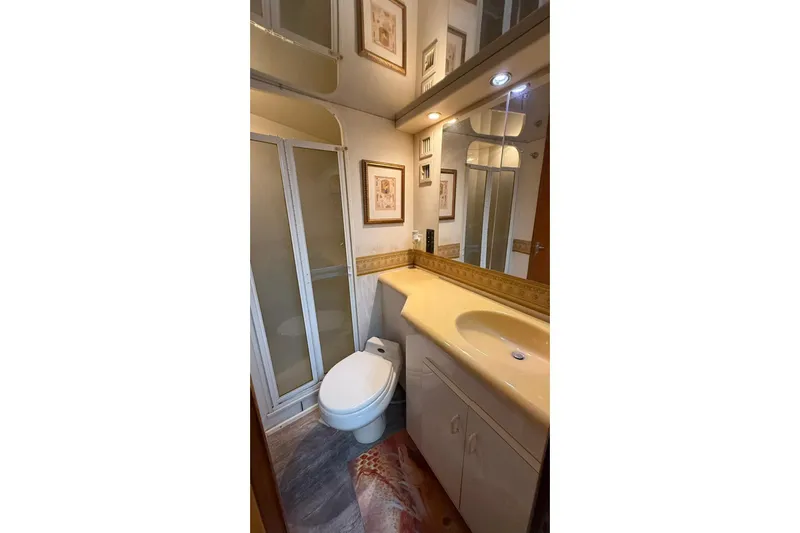 Yacht Photos Pics Bathroom interior of 1999 Viking 50 Convertible yacht with shower, sink, and toilet.