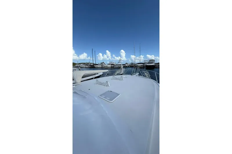  Yacht Photos Pics 1999 Viking 50 Convertible yacht docked at marina under clear blue sky.