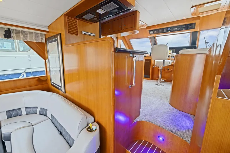 Yachtmaster Yacht Photos Pics Luxurious interior of a 2002 Symbol 58 yacht with plush seating and modern helm.