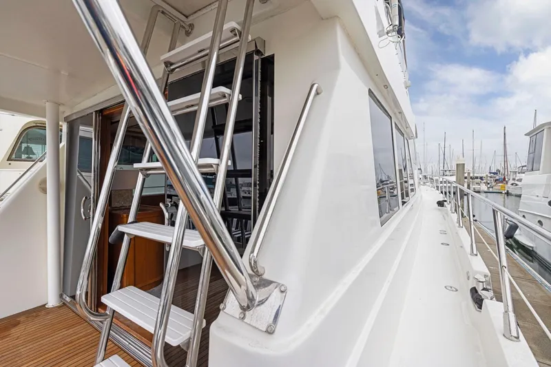 Yachtmaster Yacht Photos Pics Luxury yacht deck with stainless steel ladder, Symbol 58 model, docked at marina, 2002.