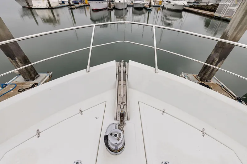Yachtmaster Yacht Photos Pics Bow of 2002 Symbol 58 yacht docked at marina with calm water.