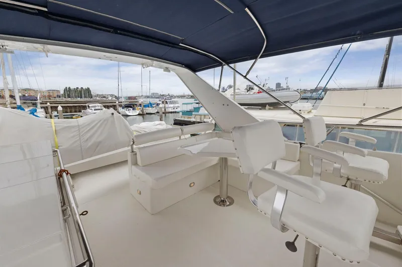 Yachtmaster Yacht Photos Pics Luxurious 2002 Symbol 58 yacht interior with white seating and marina view.