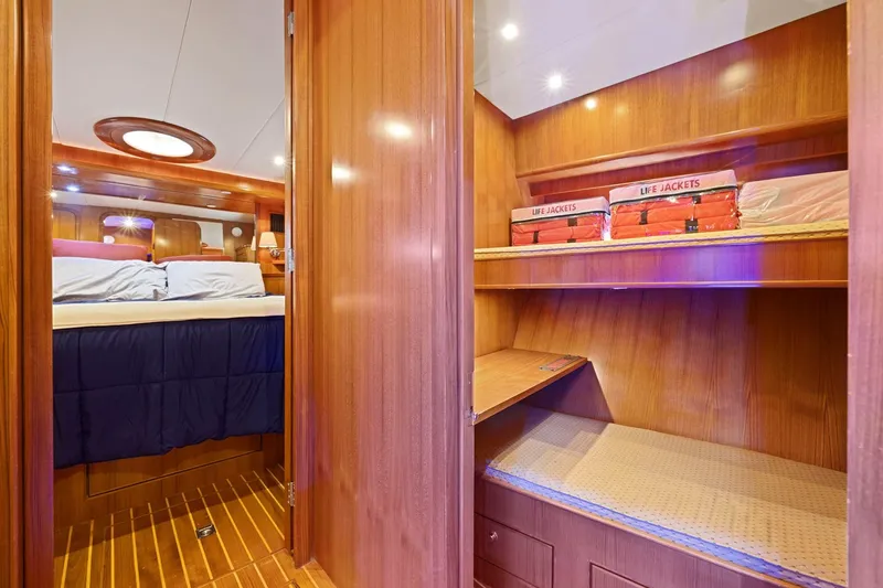 Yachtmaster Yacht Photos Pics Luxurious yacht interior with cozy bedroom and life jackets, Symbol 58, 2002 model.
