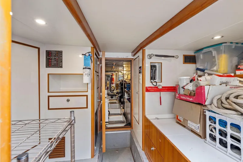 Yachtmaster Yacht Photos Pics Engine room of a 2002 Symbol 58 yacht, featuring storage and equipment.