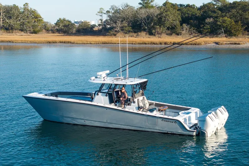Full Send Yacht Photos Pics 2024 Freeman 38 boat on calm water, featuring dual outboard motors.