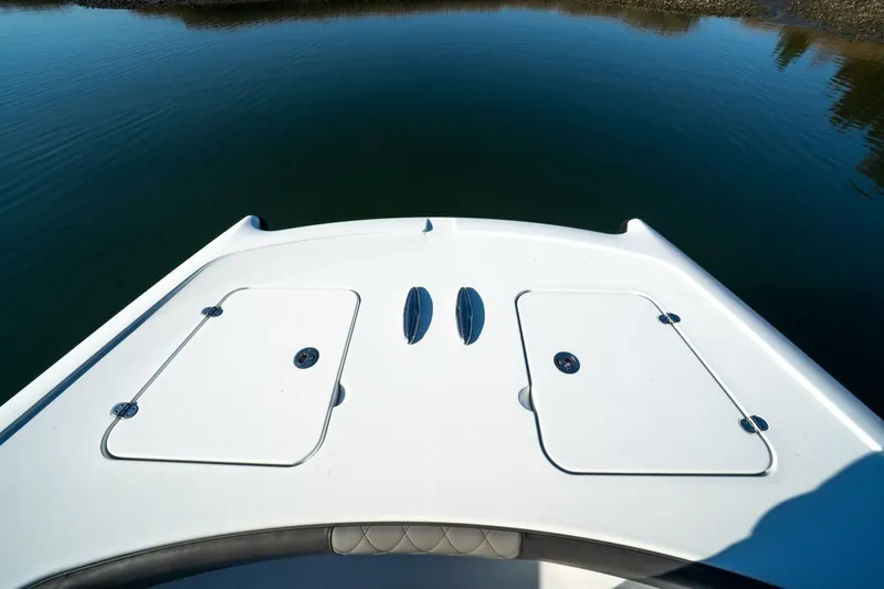 Full Send Yacht Photos Pics Bow of 2024 Freeman 38 boat on calm water, featuring storage hatches.