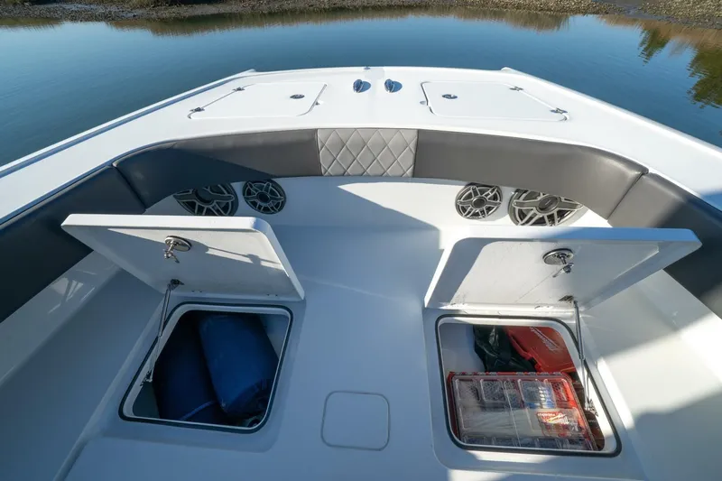 Full Send Yacht Photos Pics Bow storage compartments on a 2024 Freeman 38 boat, featuring speakers and cushioned seating.