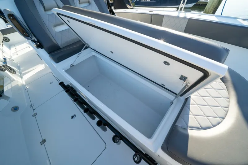 Full Send Yacht Photos Pics Open storage compartment on 2024 Freeman 38 boat with cushioned seating.