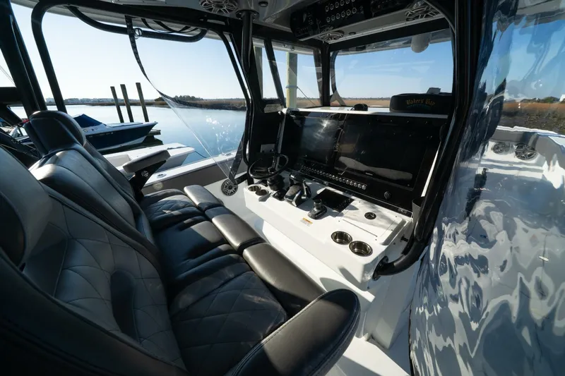 Full Send Yacht Photos Pics 2024 Freeman 38 boat interior with sleek black seating and advanced control panel.