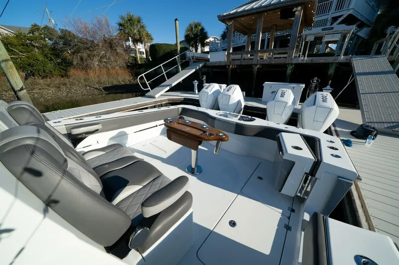 Full Send Yacht Photos Pics 2024 Freeman 38 boat interior with seating and powerful outboard engines at dock.