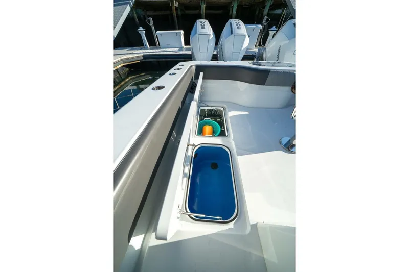 Full Send Yacht Photos Pics 2024 Freeman 38 boat deck with storage compartments and outboard motors.