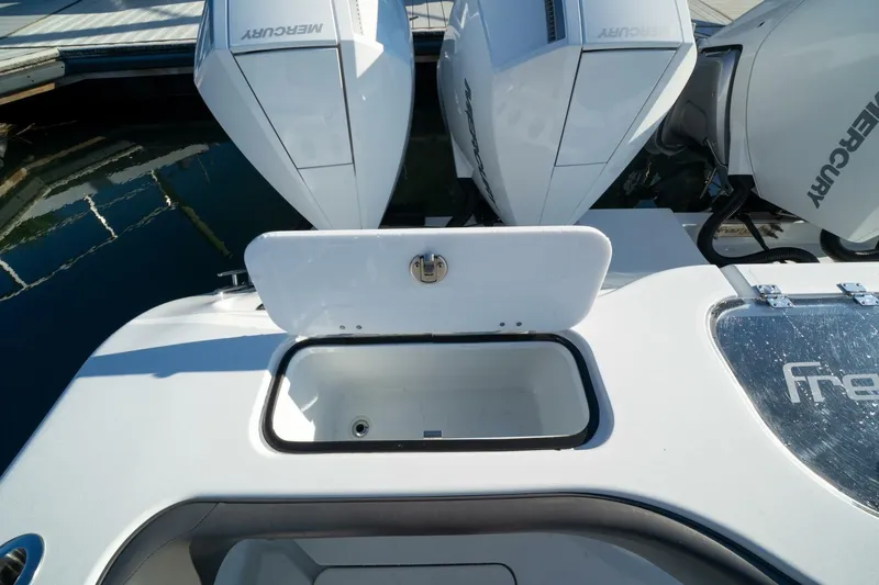 Full Send Yacht Photos Pics 2024 Freeman 38 boat with open storage compartment and Mercury engines at dock.
