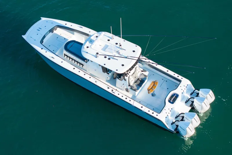 Full Send Yacht Photos Pics 2024 Freeman 38 boat with triple outboard engines on clear water.